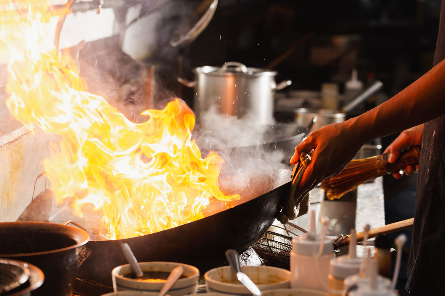Stir-frying noodles in a flaming wok at a Kepong hawker stall