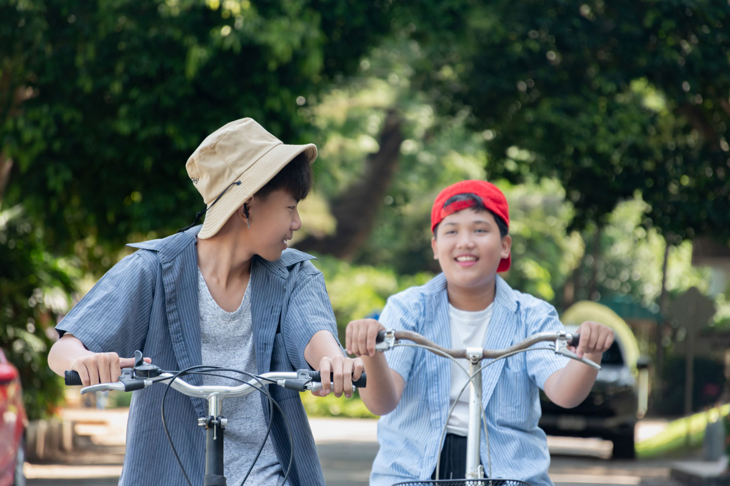 Children cycling outdoors in a green neighbourhood near Kepong