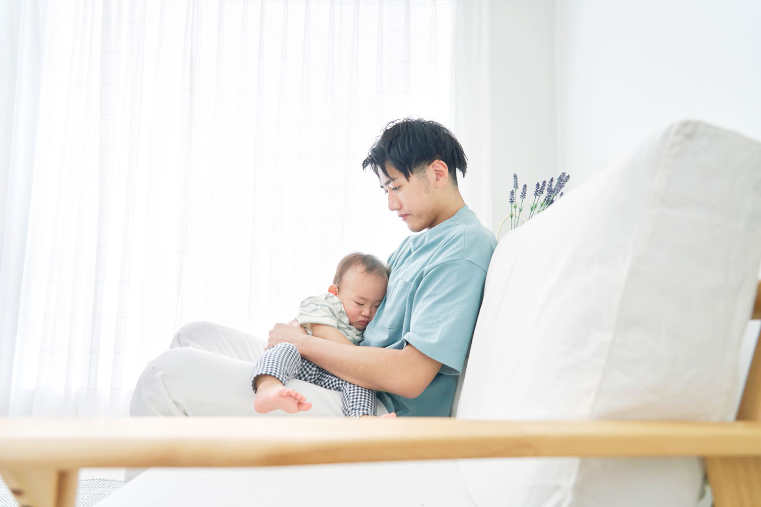 Father lulling baby to sleep